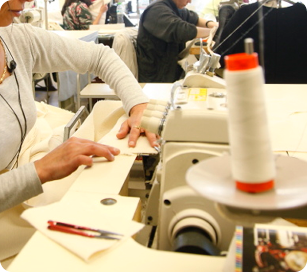 Seamstress operates overlock machine