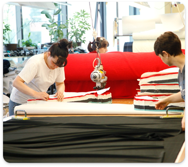 Employees using straight knife cutting machine for CMT at Mode Agency Mirage, Vratsa.