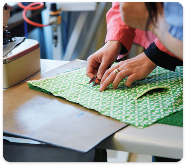 Employee at Mirage verifying measurements to geometric patterned fabric panel.