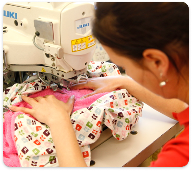 Seamstress close-up showing the sewing process of childrens accessory items.