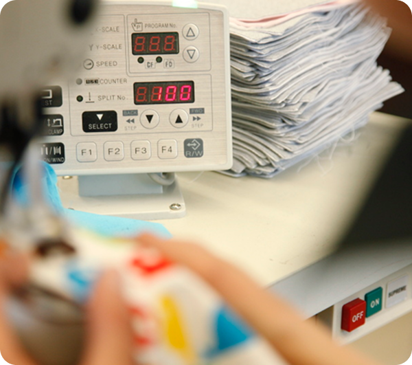 Close-up seamstress operating machine at Mode Agency Mirage