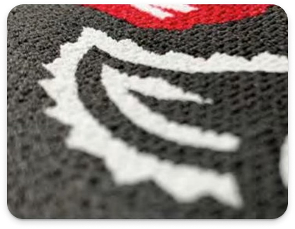 Canvas textured puff-print behind the artwork application on University wear